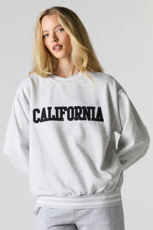 Oversized City Twill Embroidered Fleece Sweatshirt sold by Charlotte Russe