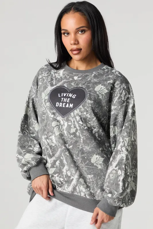 Living The Dream Embroidered Fleece Camo Sweatshirt sold by Charlotte Russe