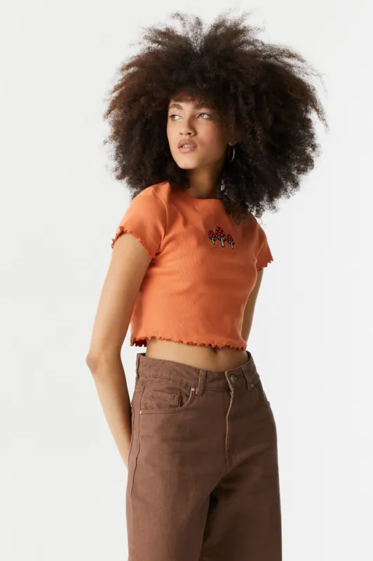 Embroidered Mushroom Graphic Lettuce Hem Cropped T-Shirt sold by Charlotte Russe