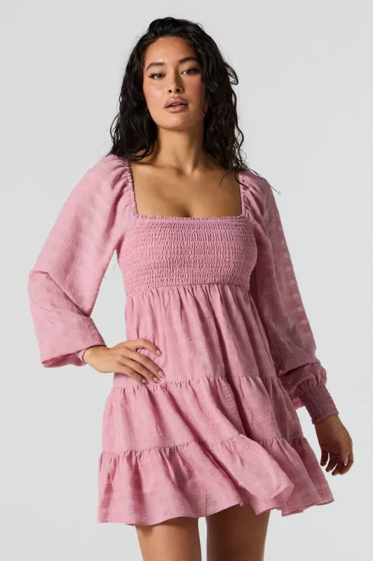 Pink Smocked Tiered Long Sleeve Mini Dress sold by Charlotte Russe