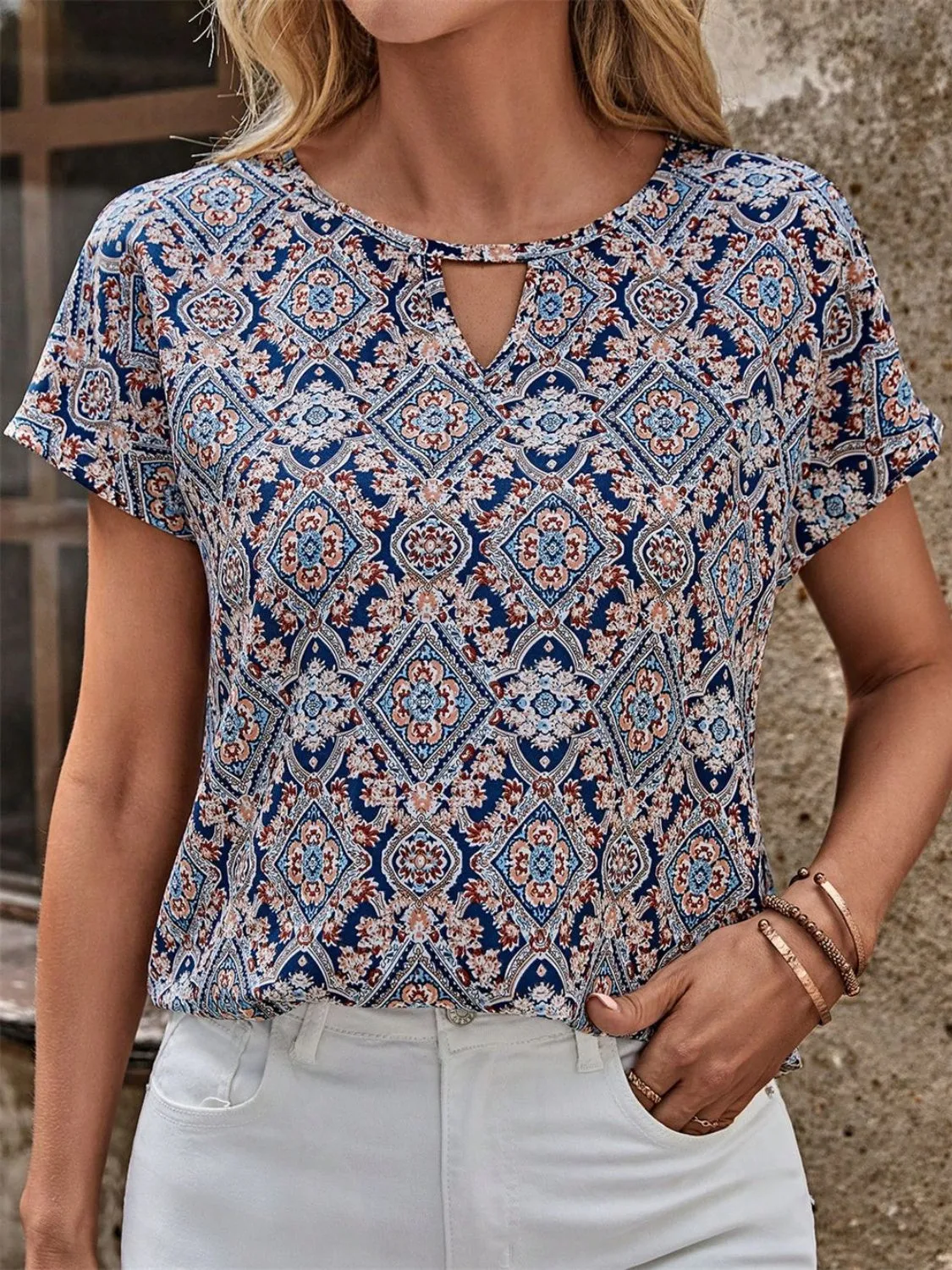 Cutout Printed Round Neck Short Sleeve Blouse sold by Charming Charlie