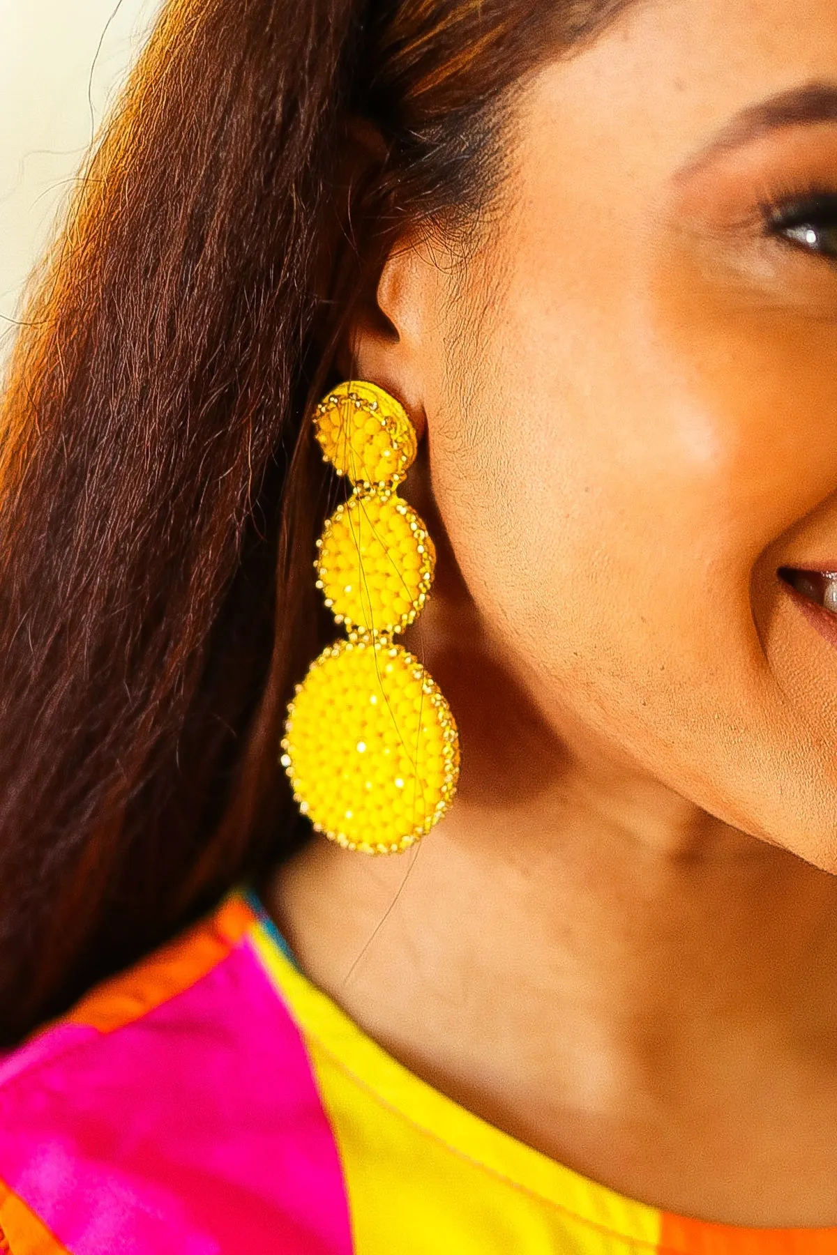 Yellow Beaded Round Pendant Earrings sold by Charming Charlie
