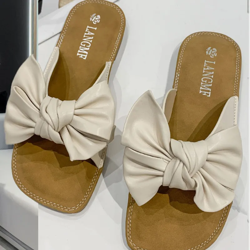 Bow PU Leather Flat Sandals sold by Charming Charlie