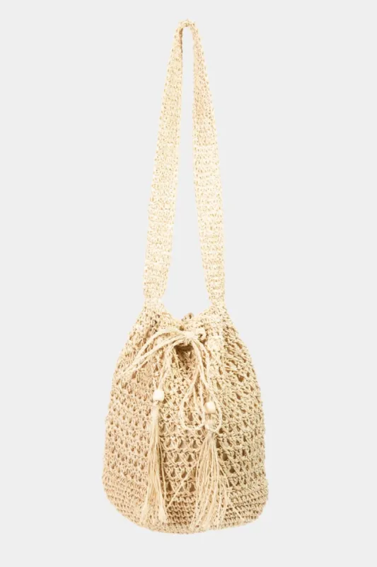Fame Straw Braided Drawstring Tote Bag with Tassel sold by Charming Charlie