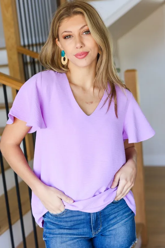 Keep Your Cool Lavender Flutter Sleeve V Neck Top sold by Charming Charlie