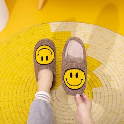 Melody Smiley Face Slippers sold by Charming Charlie