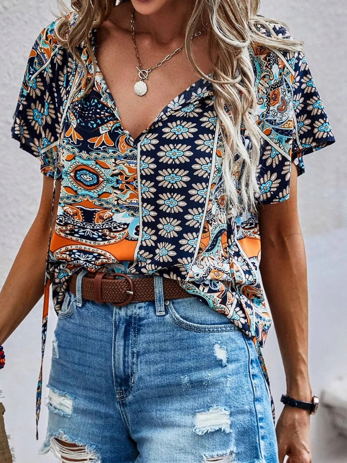 Printed Tie Neck Short Sleeve Blouse sold by Charming Charlie