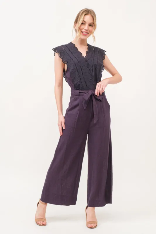 And The Why Laced Surplice Tie Waist Jumpsuit sold by Charming Charlie
