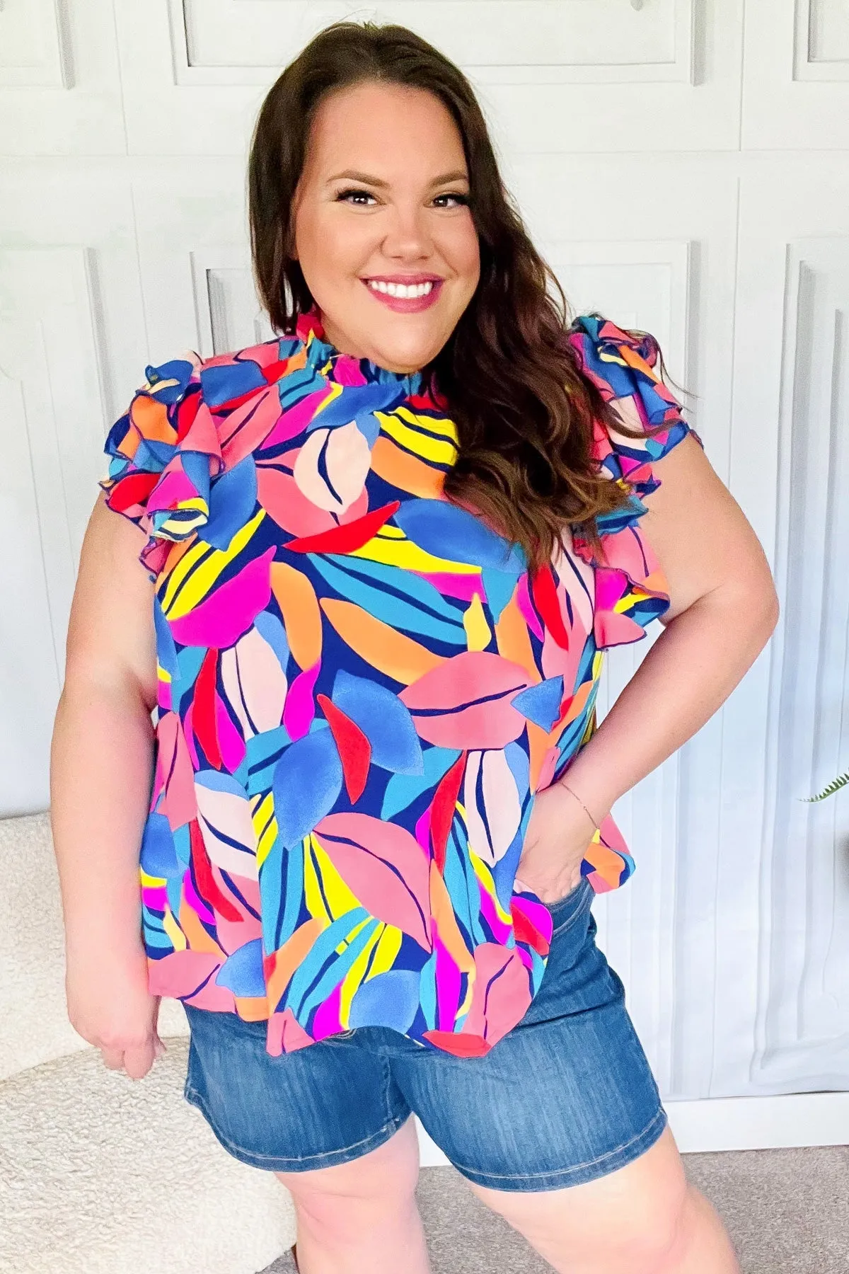 Tropical Vibes Blue & Pink Mock Neck Flutter Sleeve Top sold by Charming Charlie
