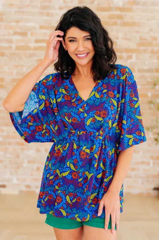 Dreamer Peplum Top in Royal and Red Abstract sold by Charming Charlie