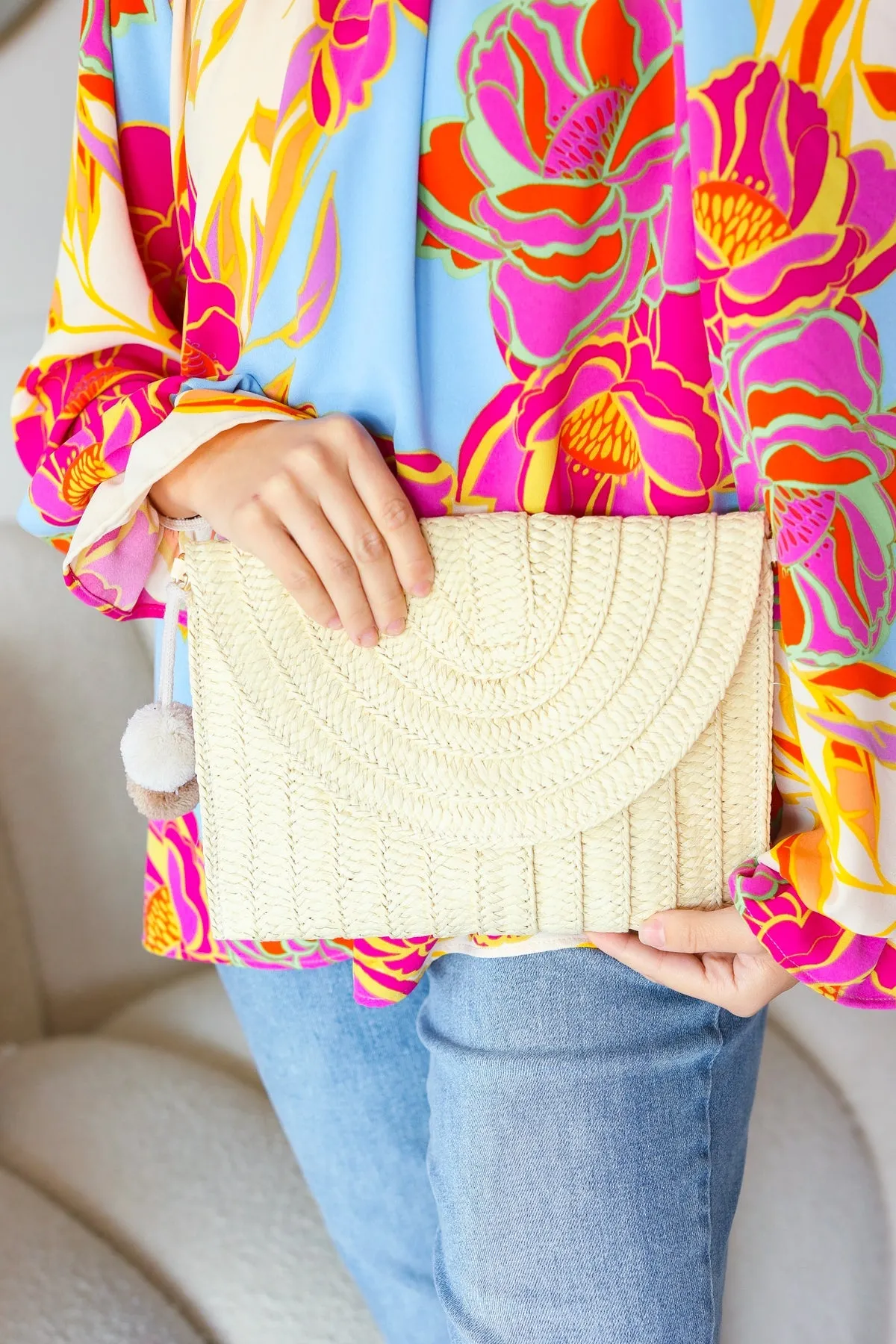Raffia Flap Closure Clutch Bag with Wrist Strap and Pom Pom sold by Charming Charlie