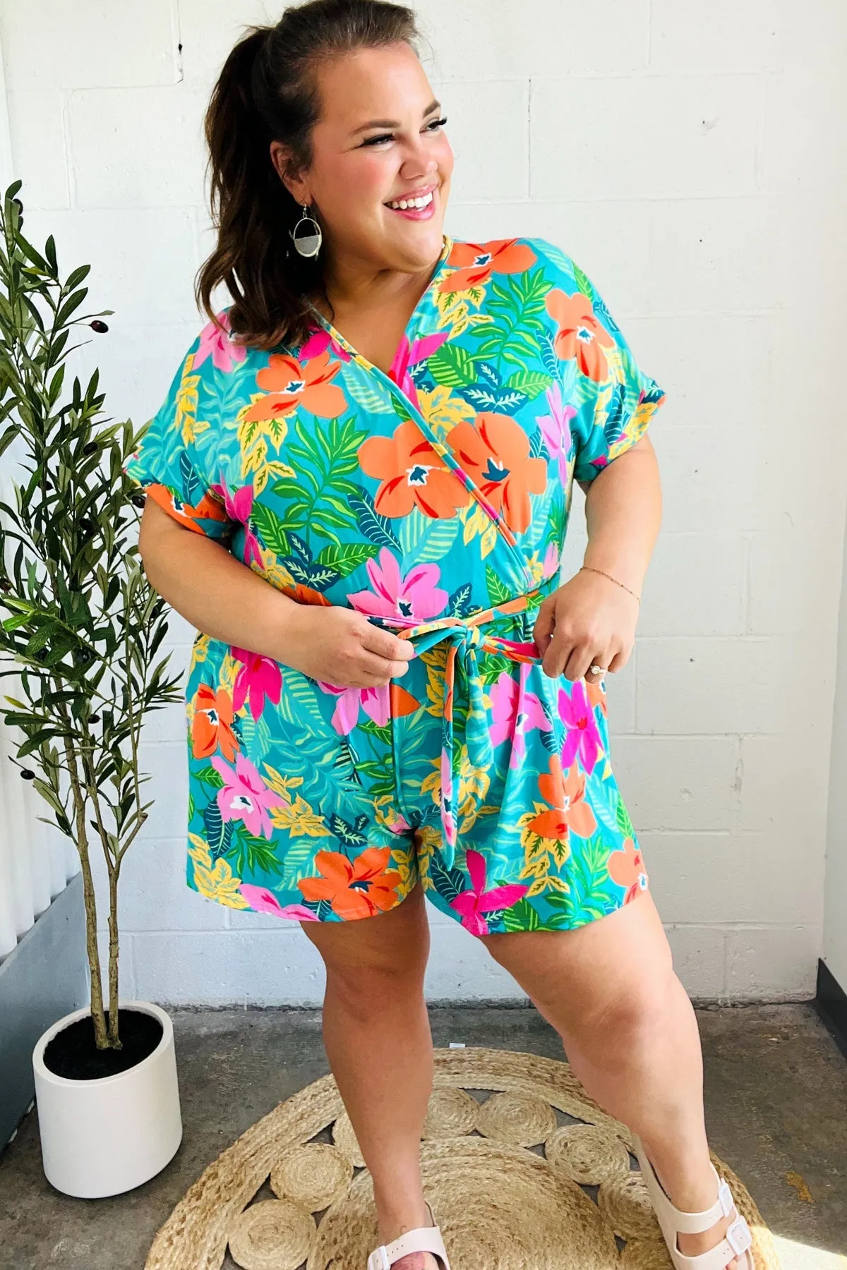 Tropical Vibes Turquoise Floral Surplice Tie Waist Romper sold by Charming Charlie