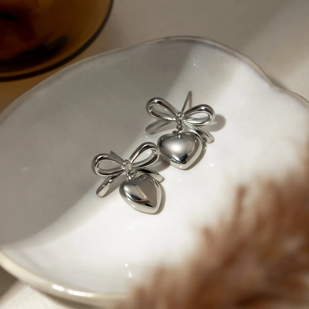 Stainless Steel Bow & Heart Drop Earrings sold by Charming Charlie product image thumbnail 4