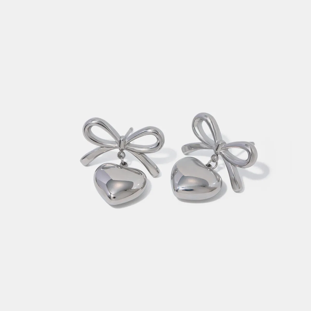 Stainless Steel Bow & Heart Drop Earrings sold by Charming Charlie