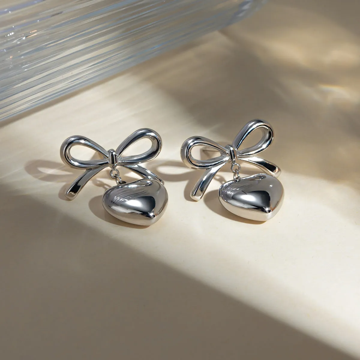 Stainless Steel Bow & Heart Drop Earrings sold by Charming Charlie product image thumbnail 2