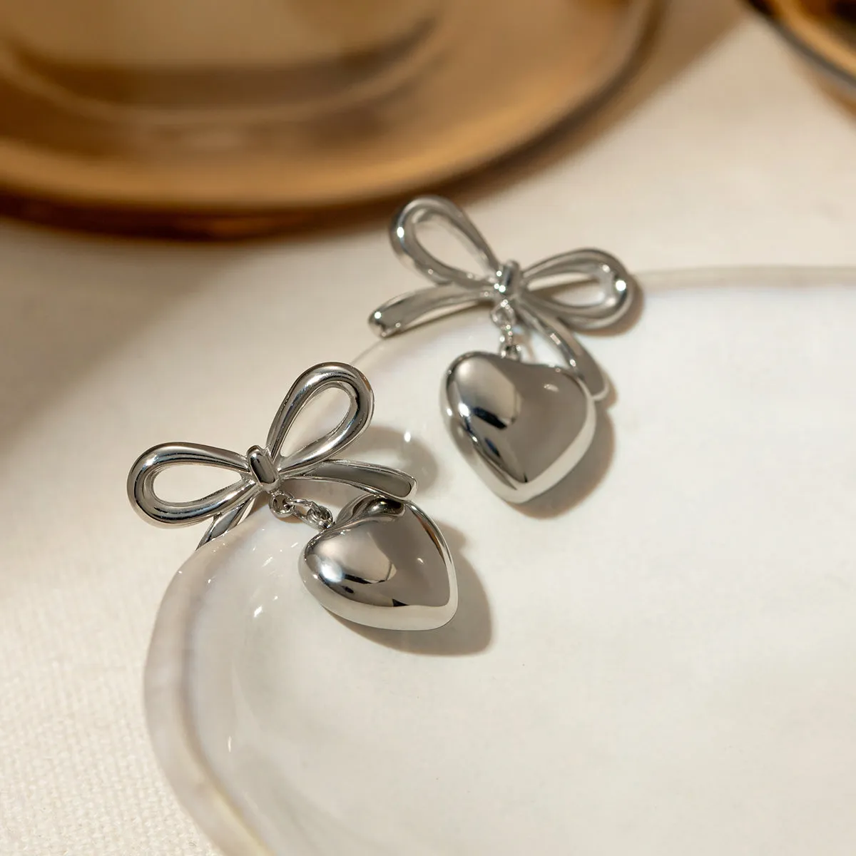 Stainless Steel Bow & Heart Drop Earrings sold by Charming Charlie product image thumbnail 3