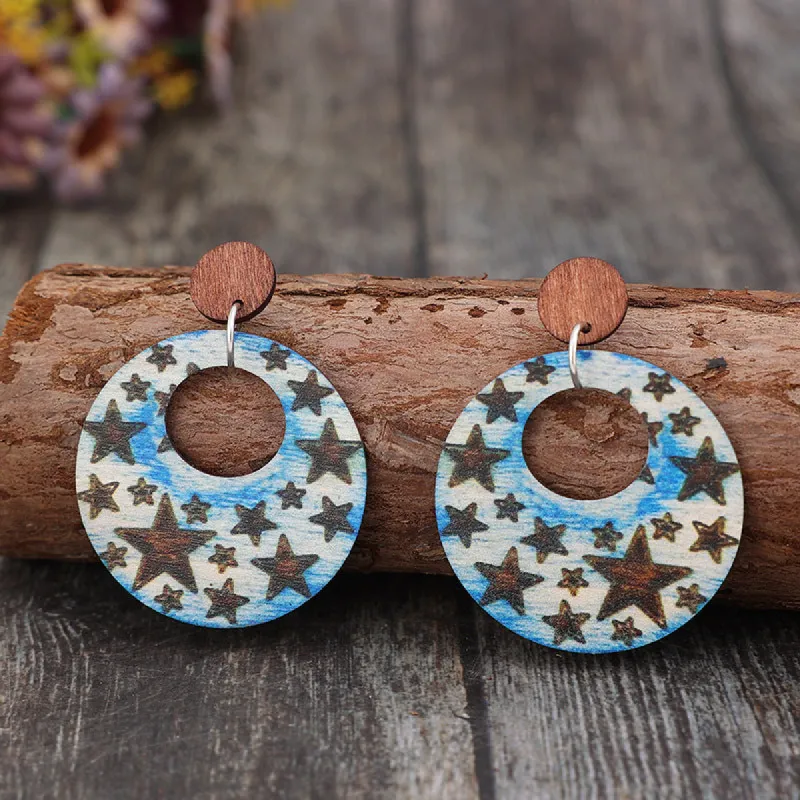Cutout Star Print Wooden Dangle Earrings sold by Charming Charlie
