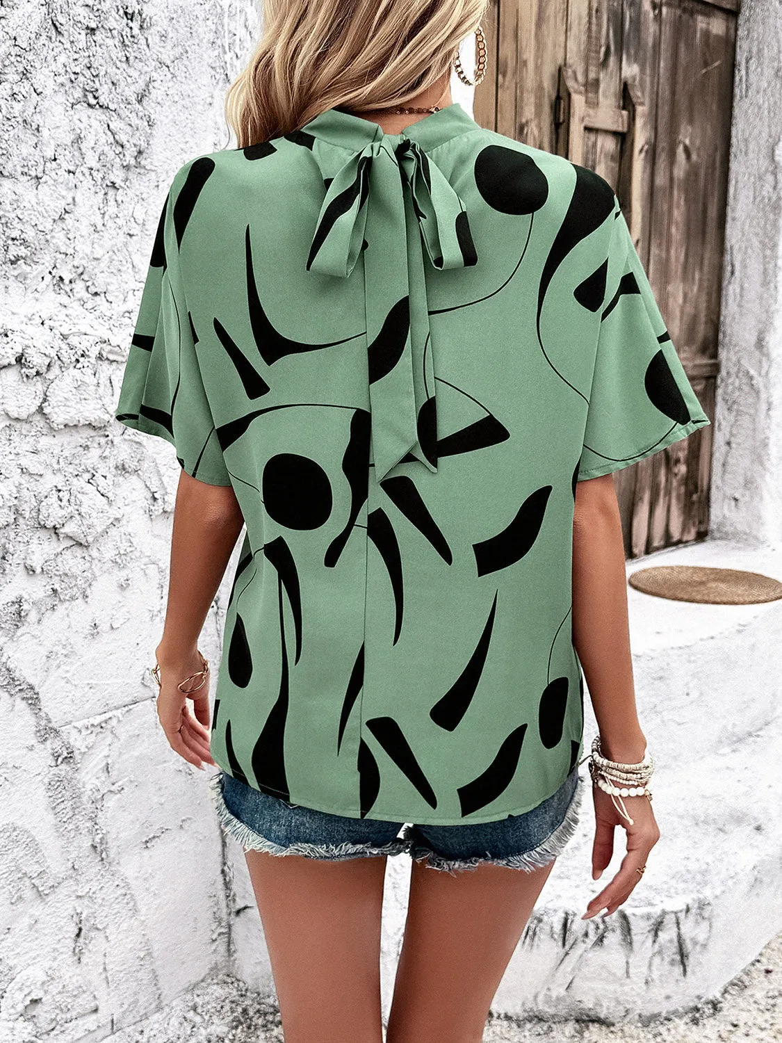 Tied Printed Mock Neck Half Sleeve Blouse sold by Charming Charlie product image thumbnail 2
