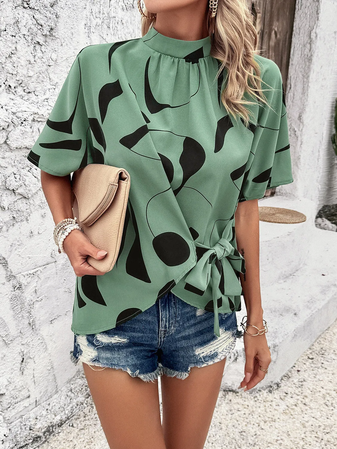 Tied Printed Mock Neck Half Sleeve Blouse sold by Charming Charlie