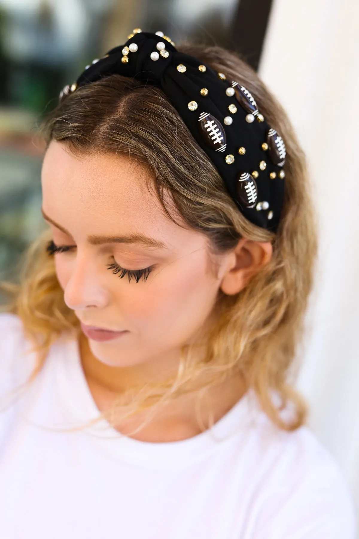 Black Stone & Gem Football Embellished Top Knot Headband sold by Charming Charlie