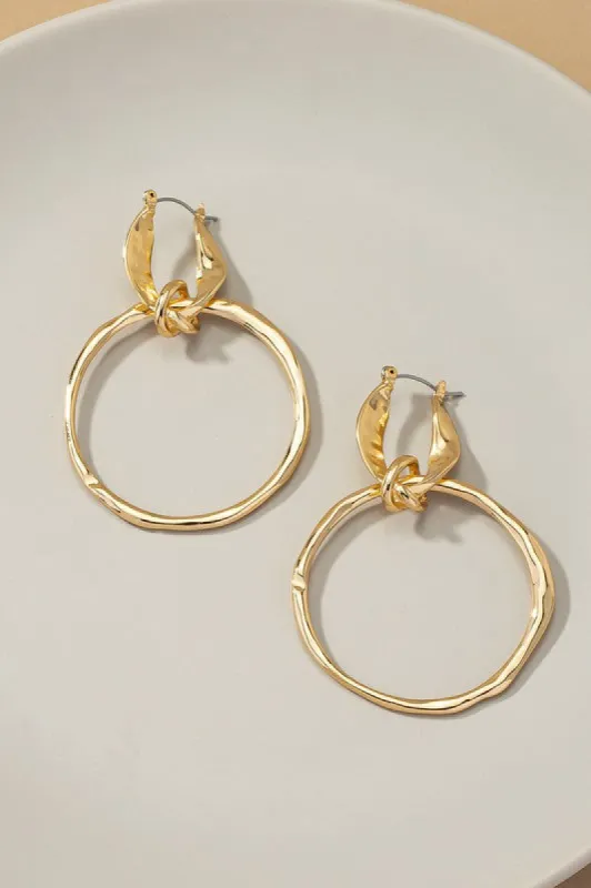 Statement hammered hoop drop earrings sold by Charming Charlie