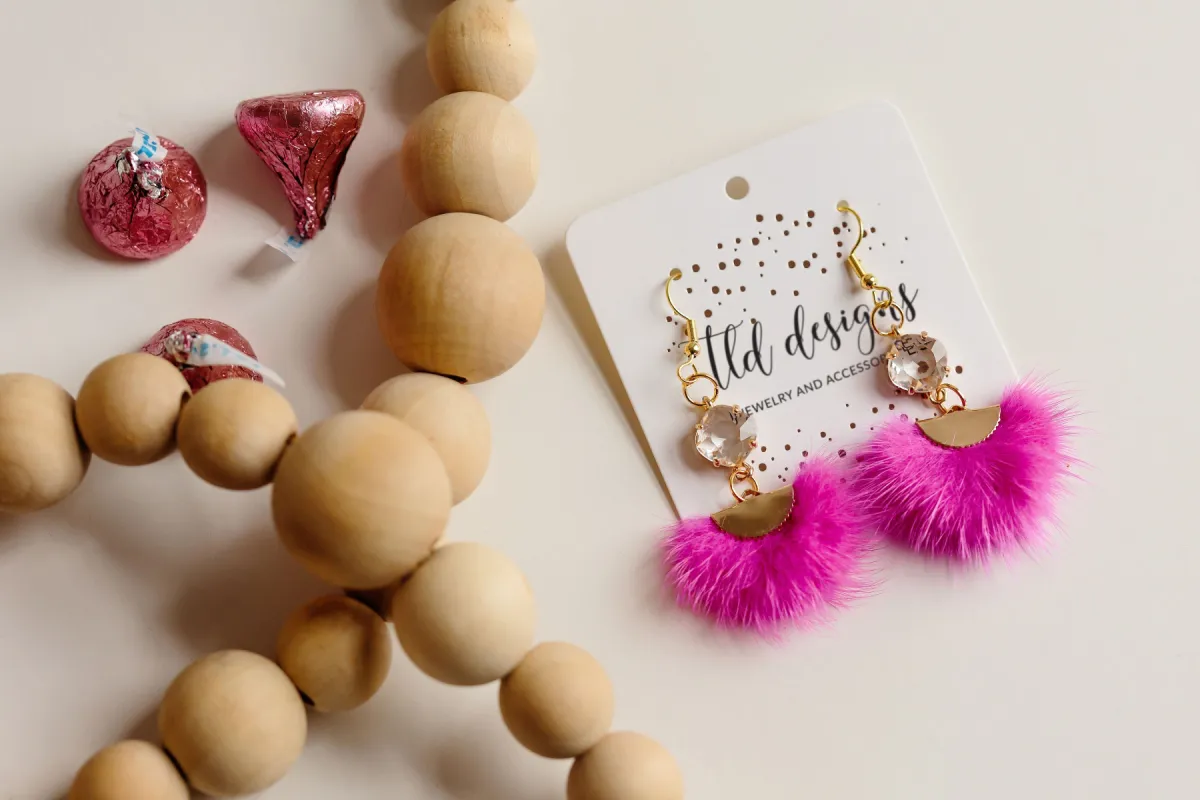 Hot Pink Dangle Puffs sold by Charming Charlie