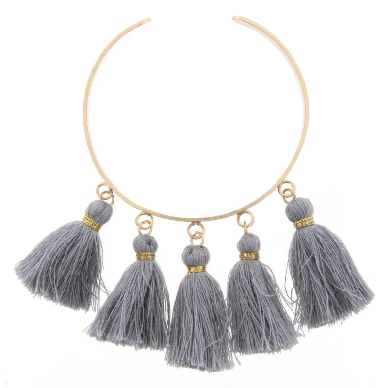 Gold Metal Cuff Bracelet with Grey Tassels sold by Charming Charlie