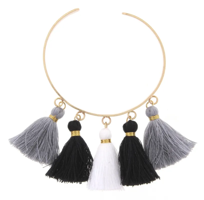 Gold Metal Cuff Bracelet with Jet, Grey, and White Tassels sold by Charming Charlie