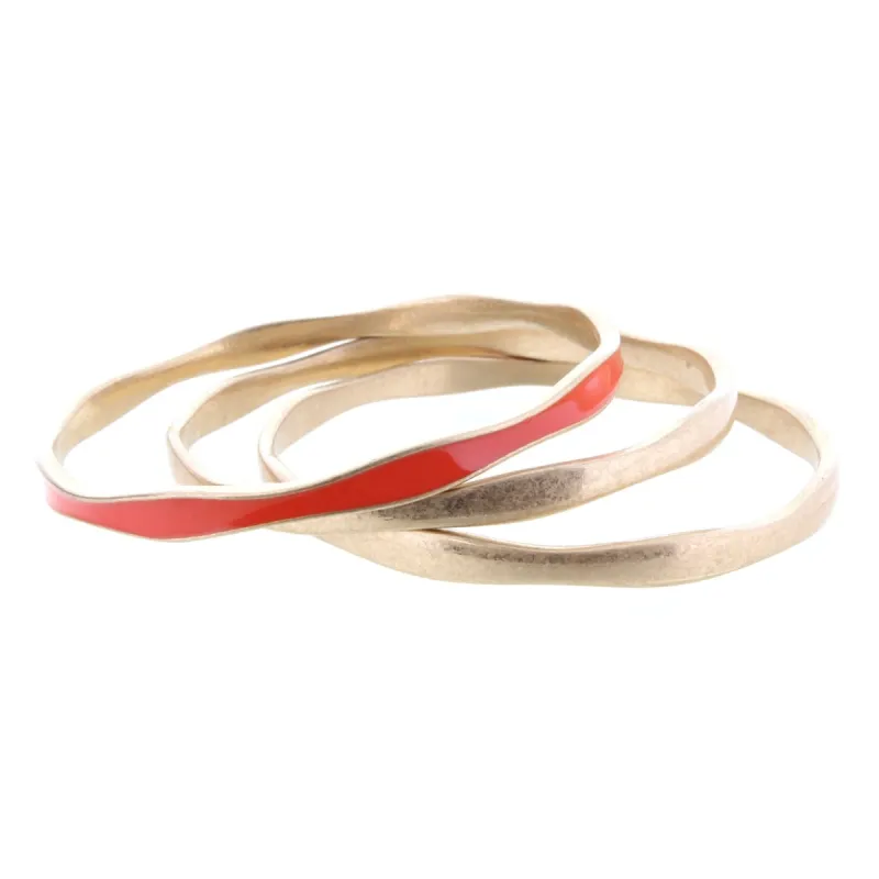 3 Gold Wavy Bangle Bracelets with One Orange Epoxy Accent sold by Charming Charlie