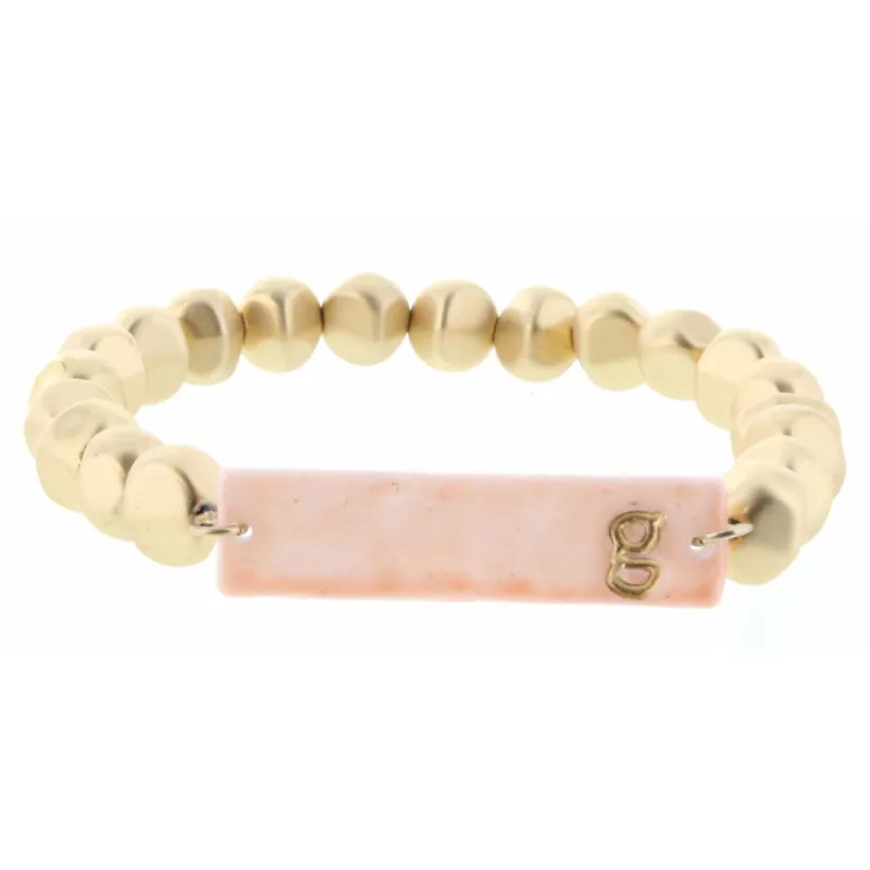 Gold Beaded Stretch, Pink Ceramic Rectangle with "G" Initial Bracelet sold by Charming Charlie