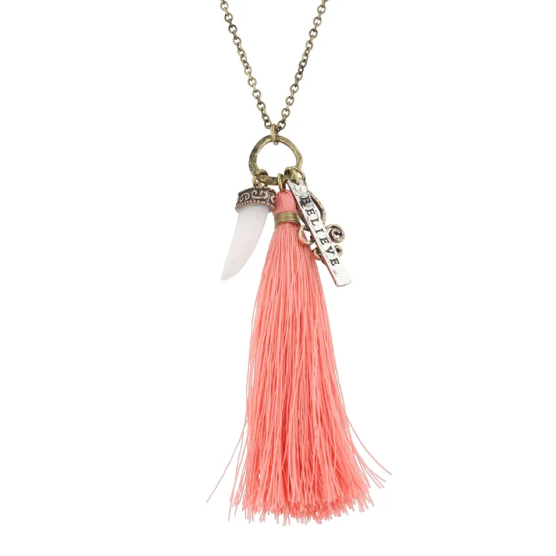 32"Gold Chain Necklace with Peach Tassel, Opaque Horn and "Believe" Charms, 3" Ext. sold by Charming Charlie
