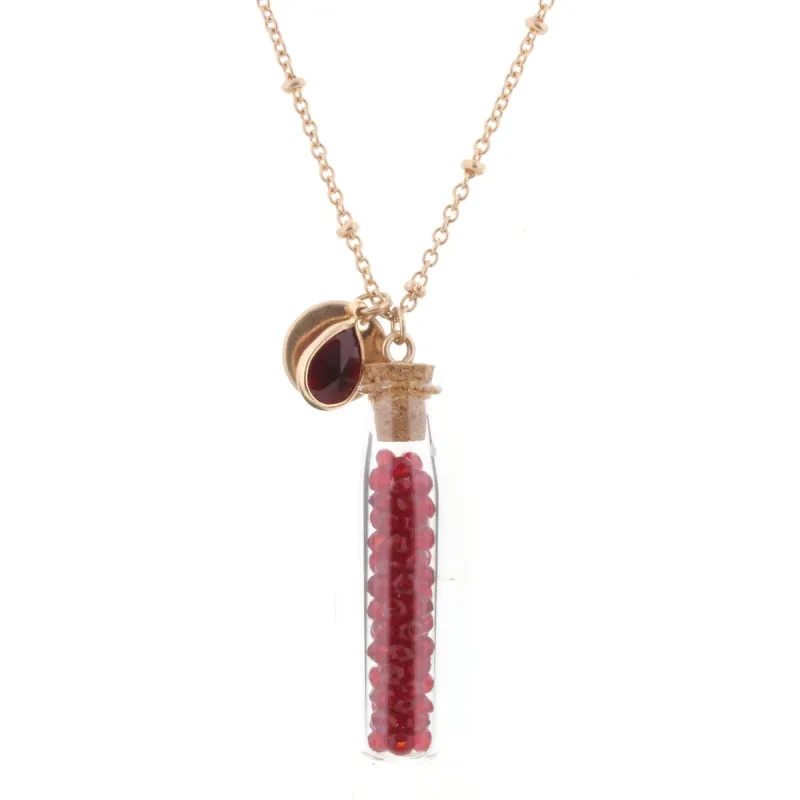 30" Necklace with Garnet Bead Filled Bottle, 3" Ext. sold by Charming Charlie