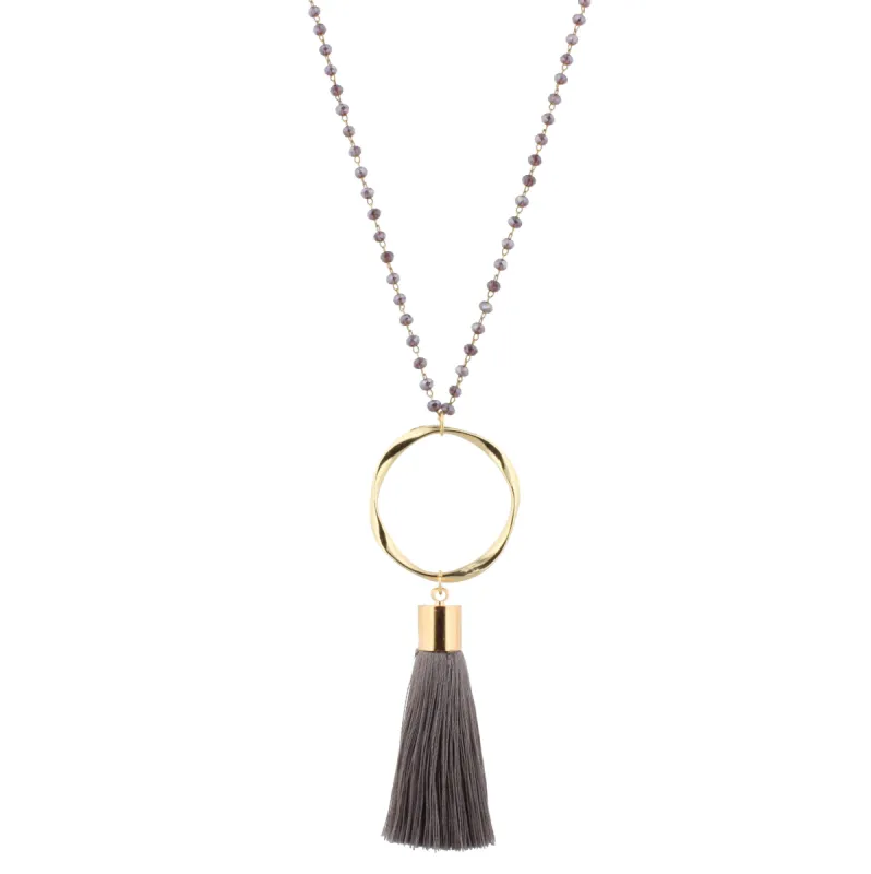 28" Dark Purple Beaded Necklace with Wavy Circle & Dark Grey Tassel, 3" Ext. sold by Charming Charlie