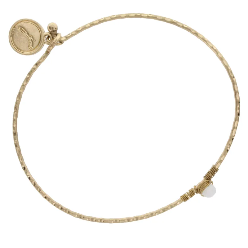 Antique Gold Bangle Bracelet with Opaque White Wire Wrapped Stone sold by Charming Charlie