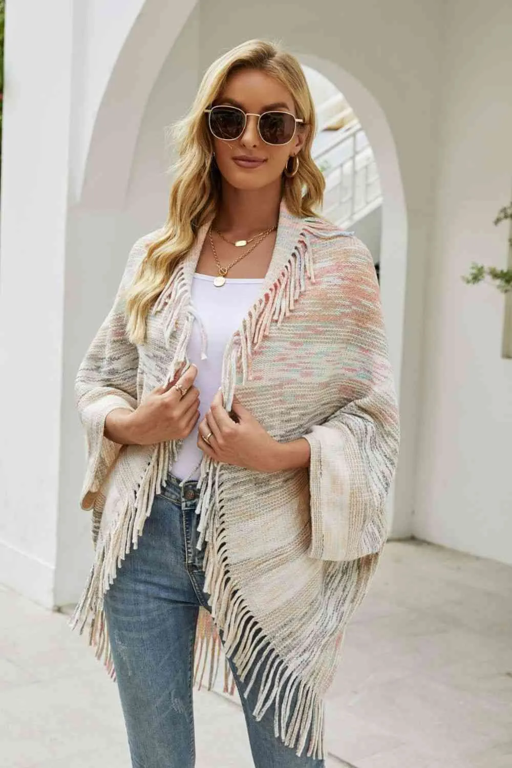 Multicolored Fringe Trim Poncho sold by Charming Charlie