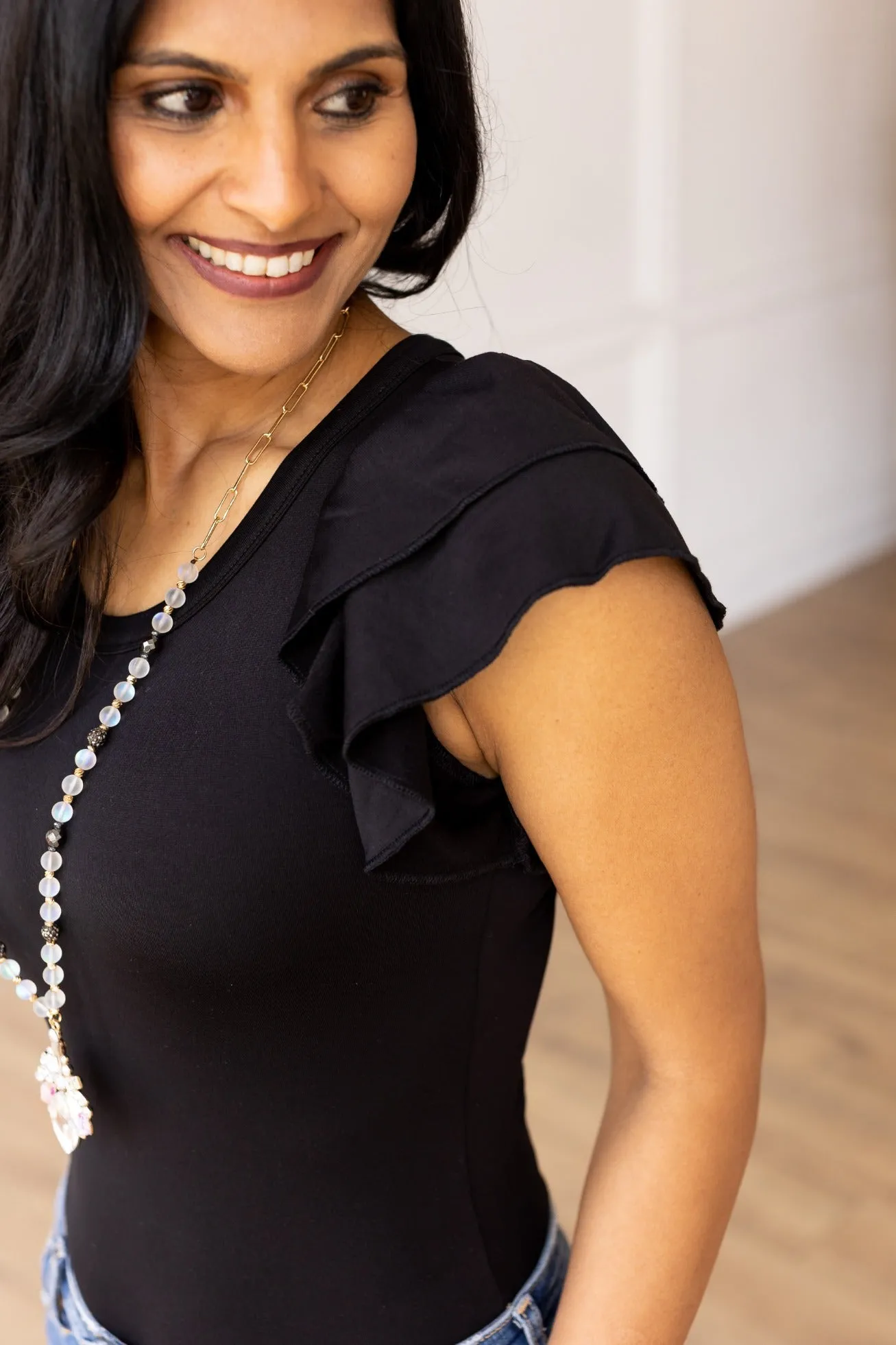 The Eloise Ruffle Sleeve Bodysuit, Black sold by Charming Charlie product image thumbnail 4