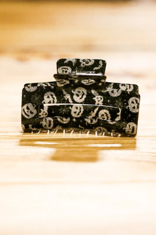 Silver & Black Glitter Jack-O-Lantern Halloween Hair Claw sold by Charming Charlie