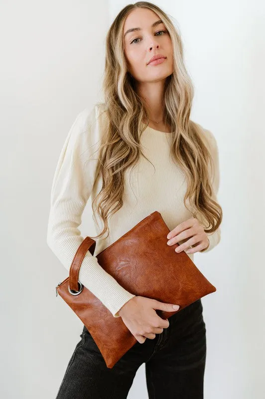 ALEXA OVERSIZED CLUTCH WITH WRISTLET sold by Charming Charlie