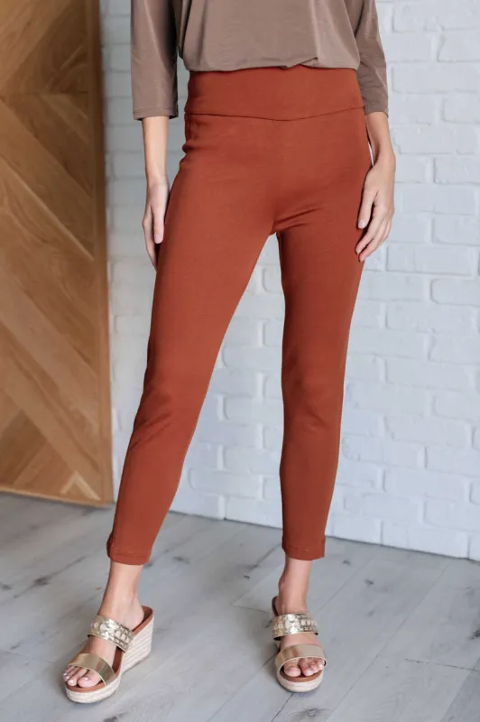 Magic Ankle Crop Skinny Pants in Rust sold by Charming Charlie