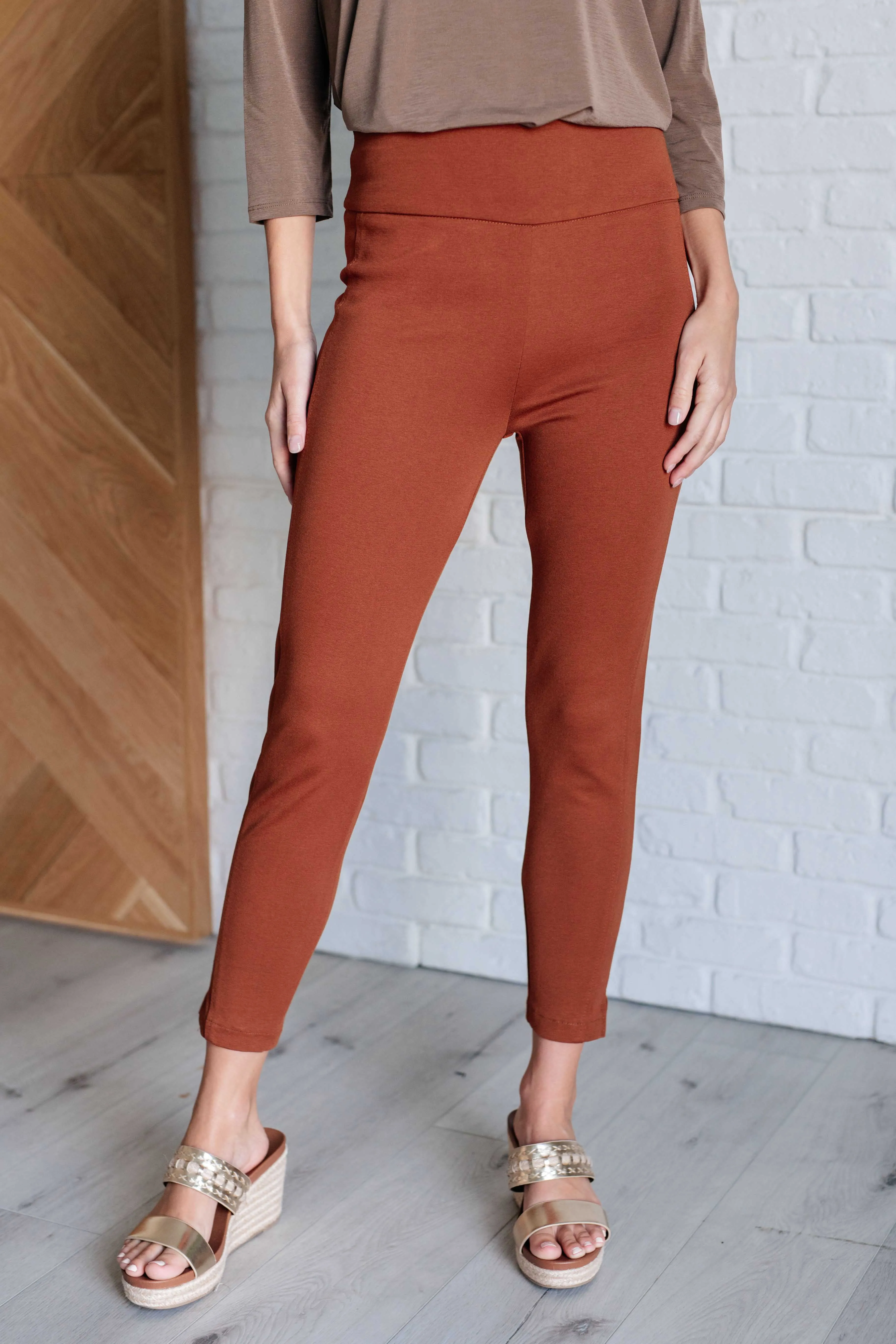 Magic Ankle Crop Skinny Pants in Rust sold by Charming Charlie