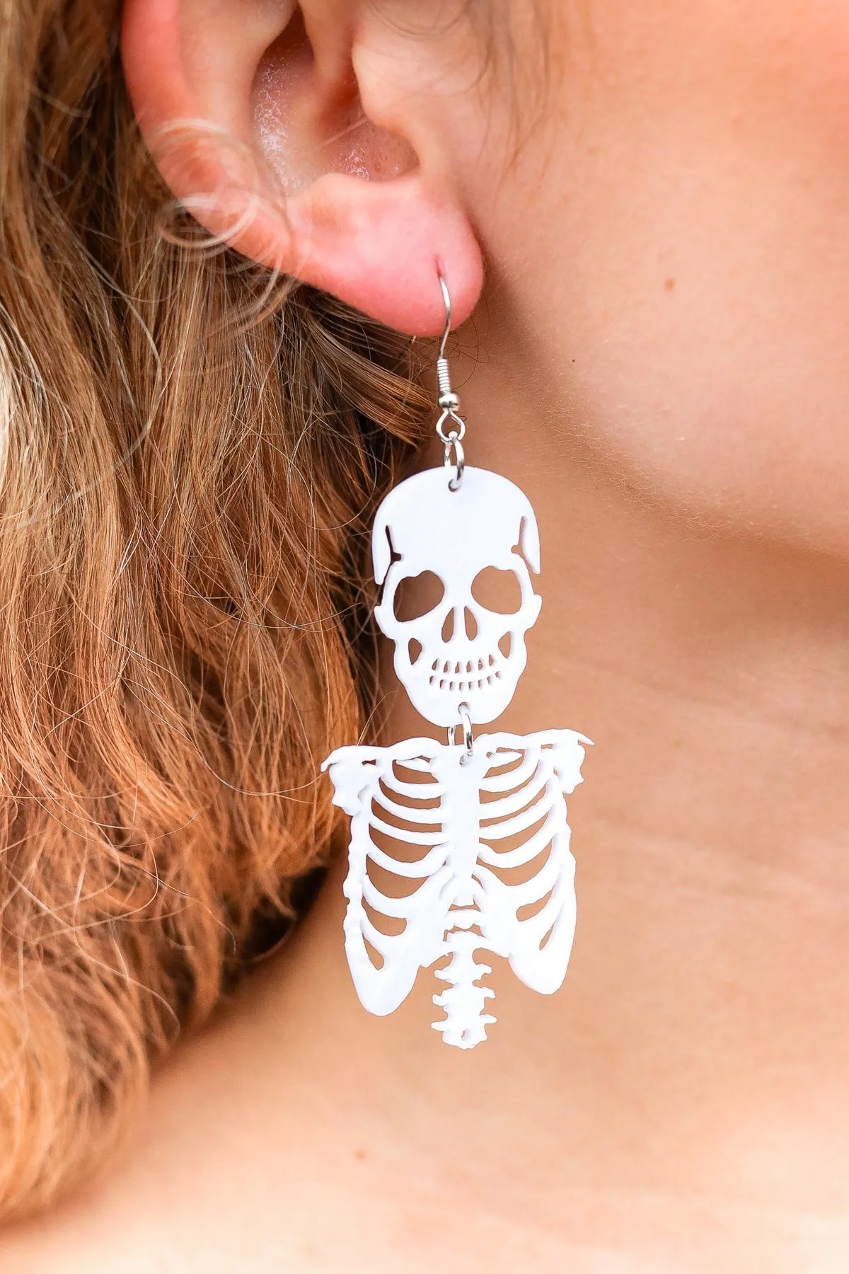 White Skeleton Acrylic Drop Earrings sold by Charming Charlie