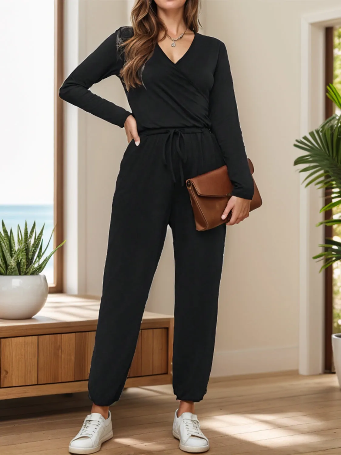 Surplice Tie Waist Long Sleeve Jumpsuit sold by Charming Charlie