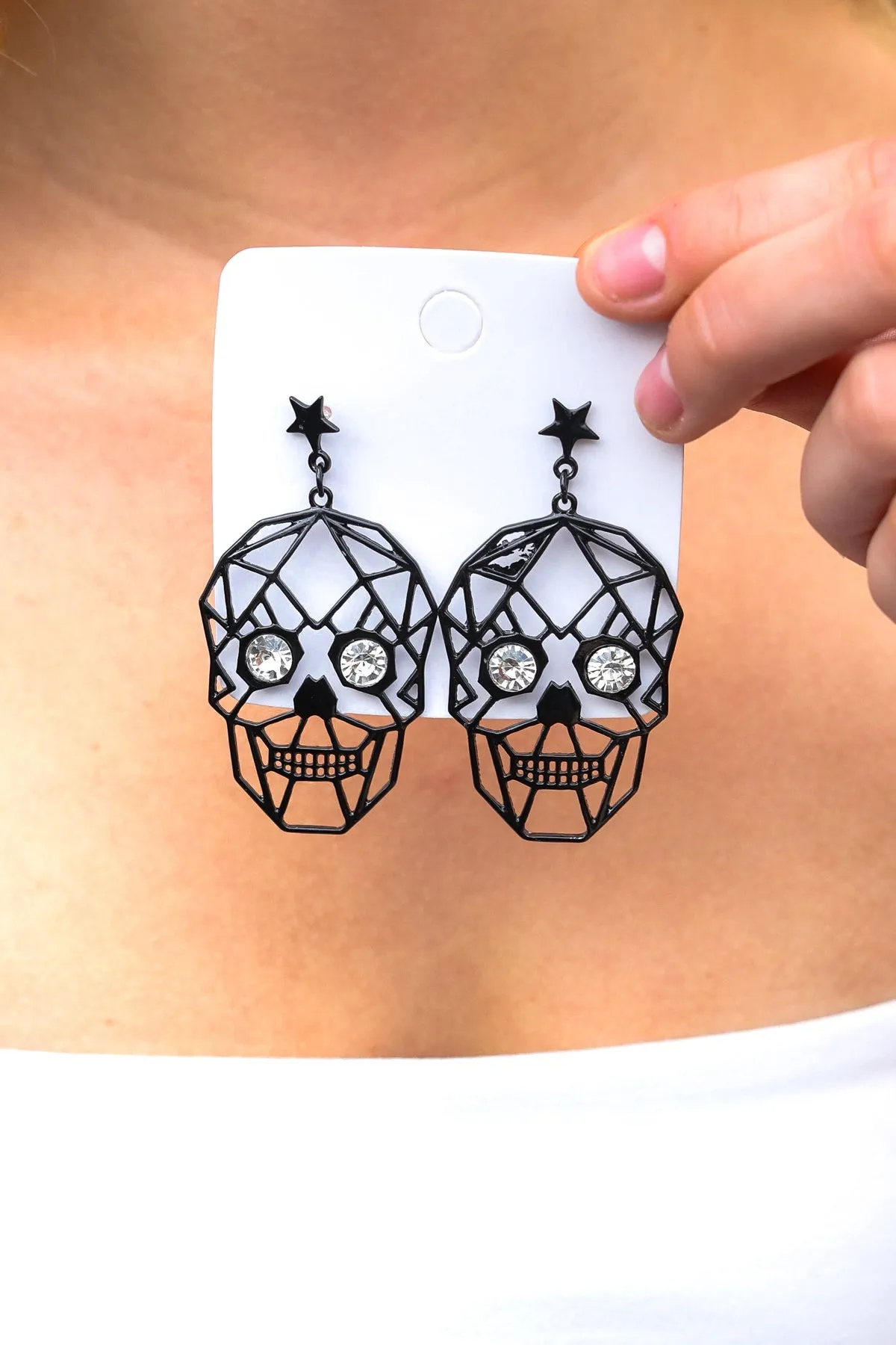 Skull Rhinestone Eyes Dangle Earrings sold by Charming Charlie