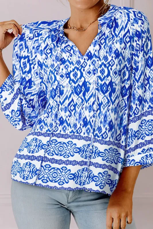 Printed Tie Neck Three-Quarter Sleeve Blouse sold by Charming Charlie