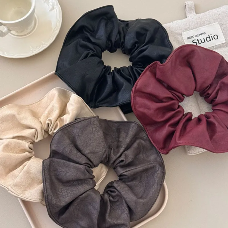 4 Piece PU Leather Elastic Hair Scrunchy sold by Charming Charlie