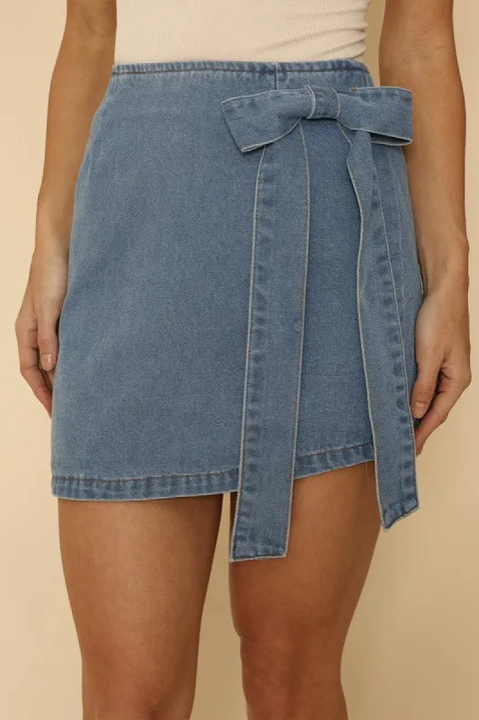 Asymmetrical denim bow skirt sold by Charming Charlie