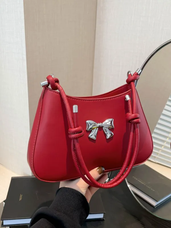 Bow PU Leather Knotted Strap Handbag sold by Charming Charlie