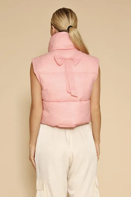 Bow cropped puffer vest sold by Charming Charlie