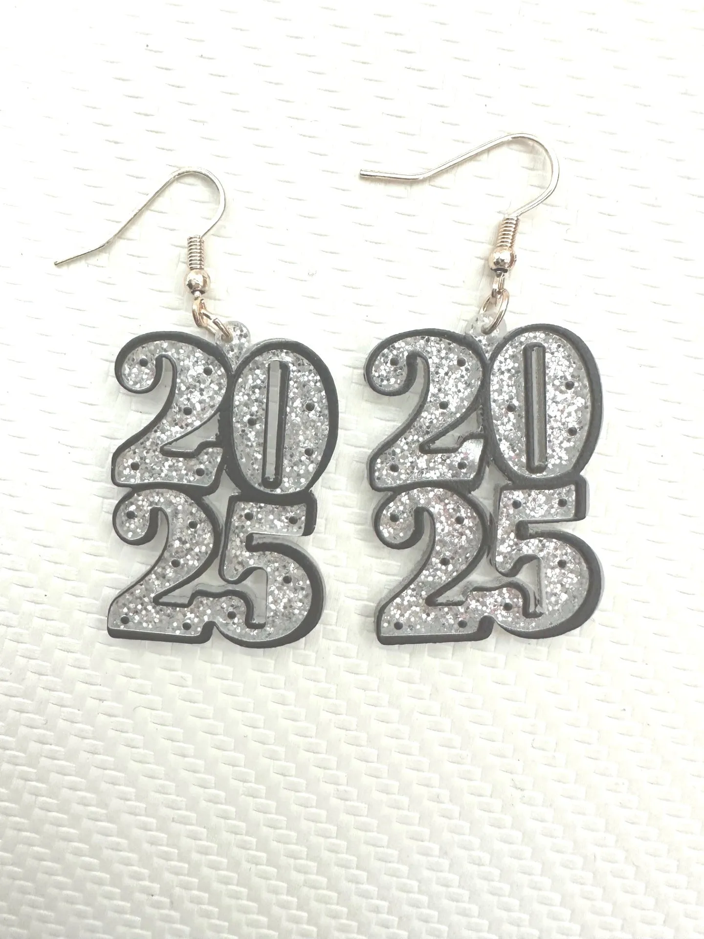 New Year's 2025 Silver Glitter Dangle Earrings sold by Charming Charlie