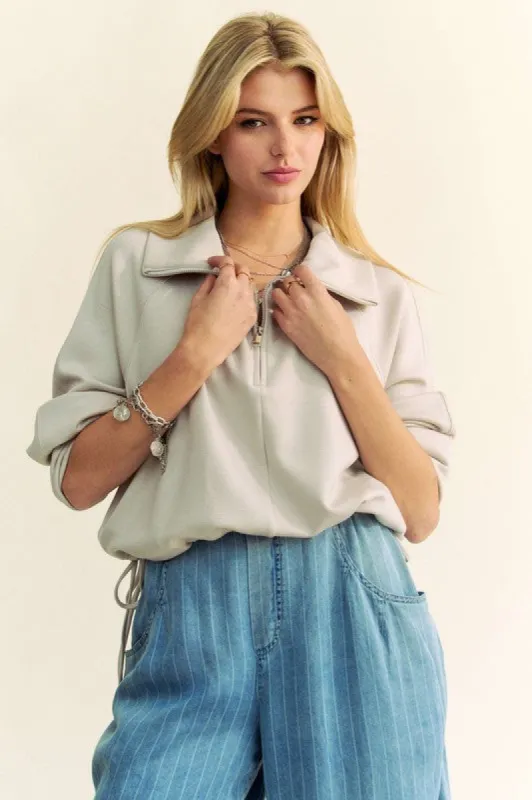 Davi & Dani Drawstring Hem Half Zip Raglan Sleeve Sweatshirt sold by Charming Charlie